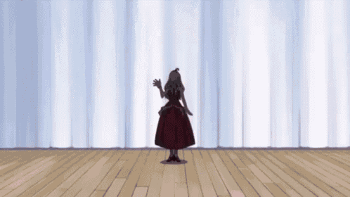 a silhouette of a woman in a red dress is standing on a stage