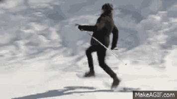 a person is skiing down a snowy slope .