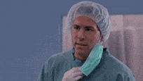 a surgeon wearing a surgical cap and mask is talking on a cell phone and saying `` but why '' .