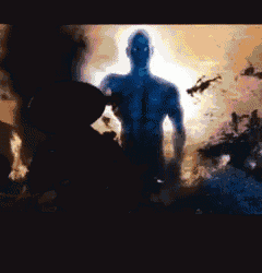 a silhouette of a man in a dark room with a glowing light behind him