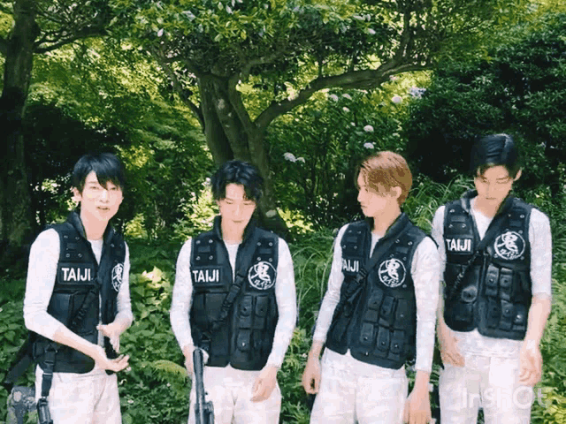 a group of young men wearing taiji vests stand in a forest