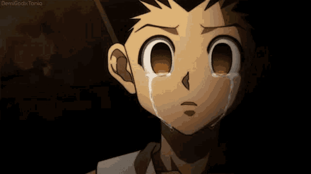 a close up of a person 's face with a tear coming out of it .