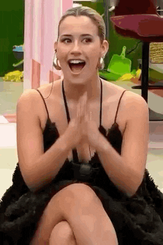 a woman is sitting on the floor with her legs crossed and her mouth open .