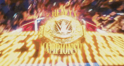 a heavyweight championship belt is being displayed on a stage with a crowd in the background .