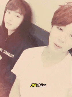 a couple of people standing next to each other with jm kiss written on the bottom right