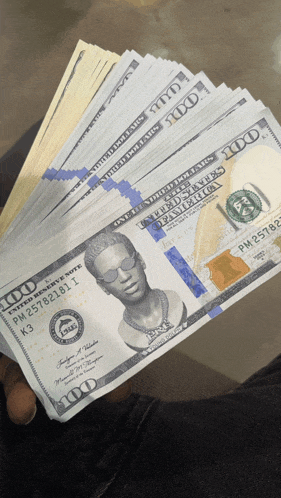 a stack of 100 dollar bills with a man 's face on them