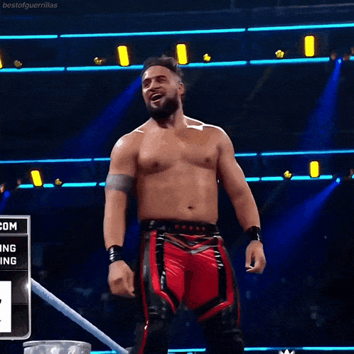 a shirtless wrestler is standing in front of a sign that says ' atlanta ' on it