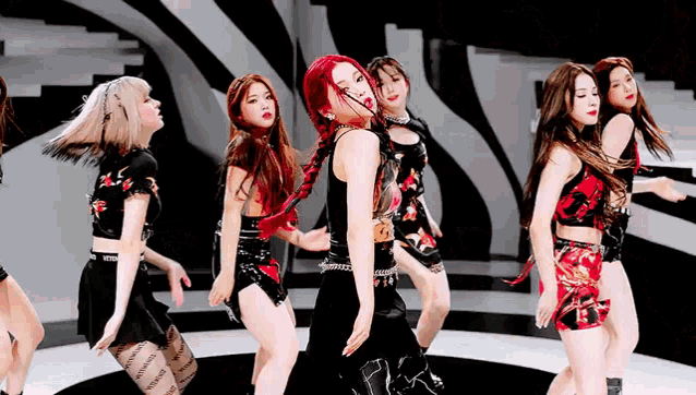 a group of women are dancing together on a stage .