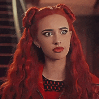 a woman with red hair making a silly face