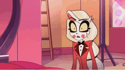 a cartoon character wearing a tuxedo and bow tie is sitting on a bed .