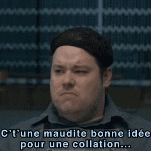 a man in a gray shirt says " c'une maudite bonne idee pour une collation "