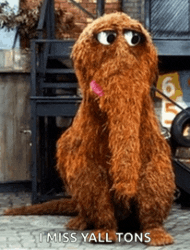 elmo from sesame street says i miss yall tons while sitting on the sidewalk