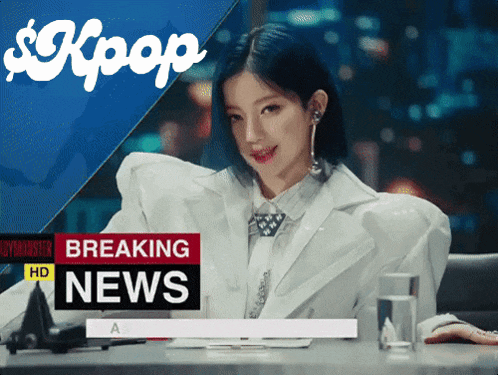 a woman sitting at a desk with a breaking news sign above her