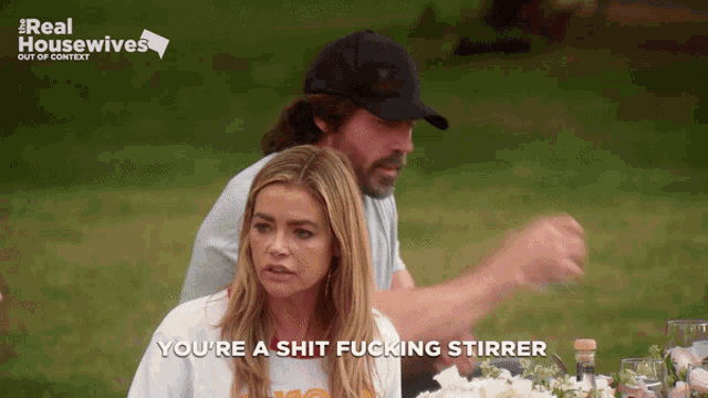 a woman says you 're a shit fucking stirrer while a man looks on