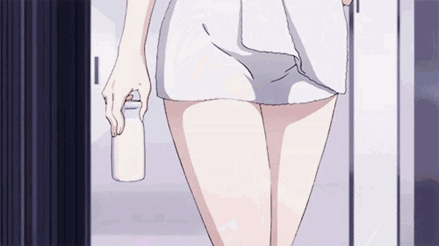 a woman is holding a bottle of milk in her hand