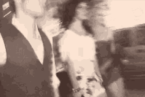 a man and a woman are standing next to each other .