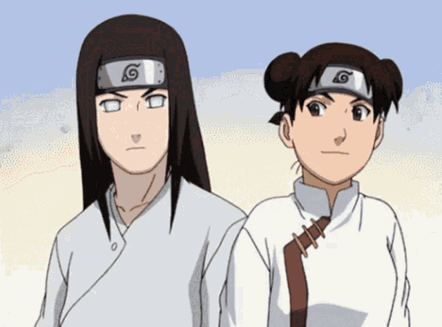 a boy and a girl are standing next to each other and the boy has a headband with a g on it