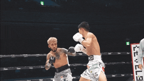 a man in a boxing ring with g7 on the shorts