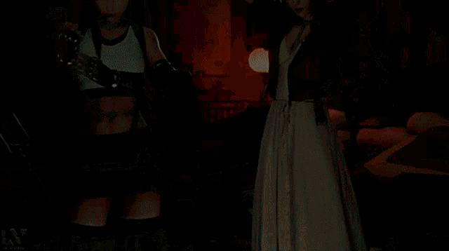 two women are standing next to each other in a living room .