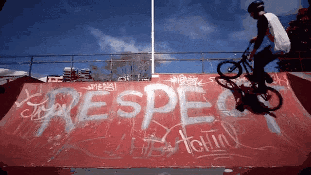 a person is riding a bike on a ramp with the word respect written on it