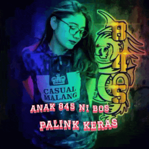 a woman wearing a casual malang shirt stands in front of a wall