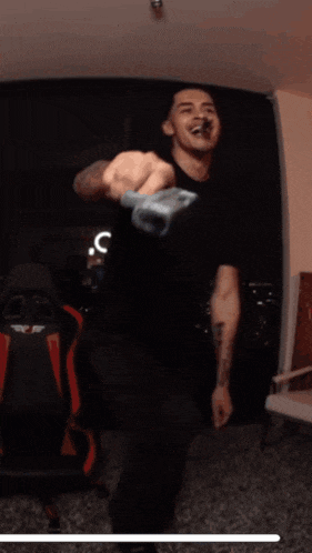 a man with a tattoo on his arm is holding a wrench in his hand