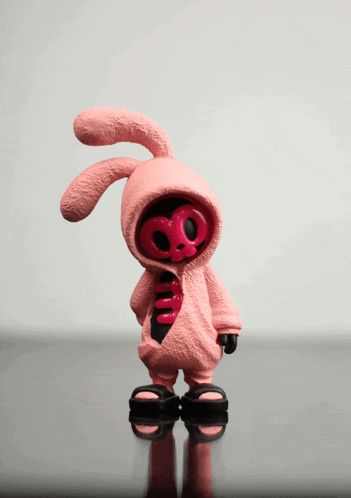 a pink bunny figurine with a skull on it 's chest