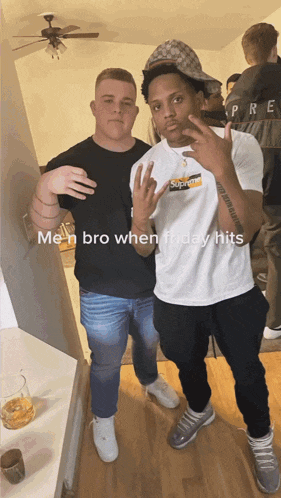 two men are posing for a picture and one has a supreme shirt on