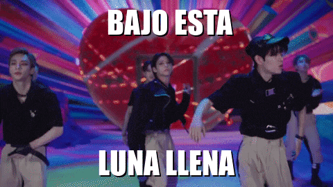 a group of people are dancing with the words bajo esta luna llena written above them