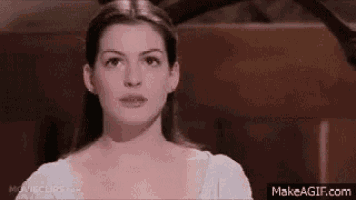 a close up of a woman 's face in a white dress .