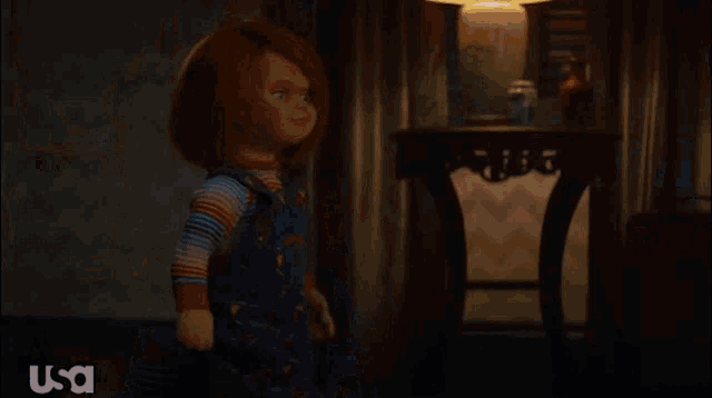 a child 's play doll is holding a sparkler in his hand .