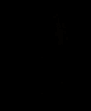 a woman sits on a couch in a dark living room