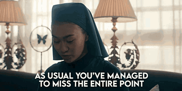 a nun sitting on a couch with the words " as usual you 've managed to miss the entire point " below her