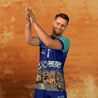 a man wearing a blue and green shirt that says pyguy