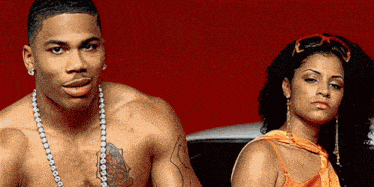 a man without a shirt is standing next to a woman
