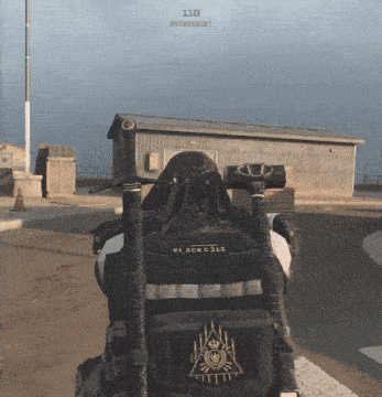 a person wearing a black vest with the word black gold on it