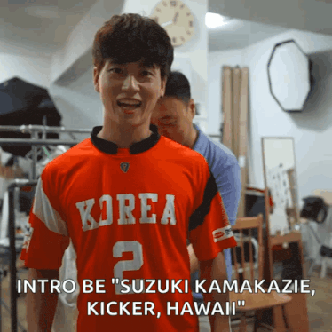 a man wearing a red korea jersey with the number 2