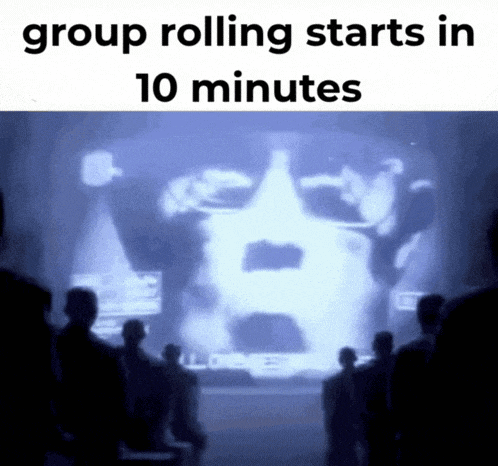 a group of people looking at a screen that says group rolling starts in ten minutes