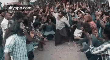 a group of people are dancing in a crowd .