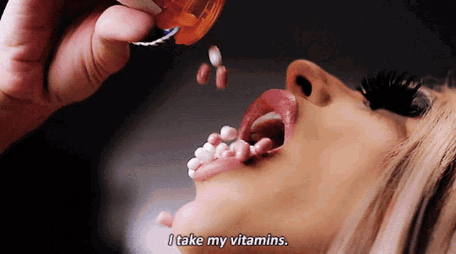 a woman is taking vitamins and says " i take my vitamins " at the bottom