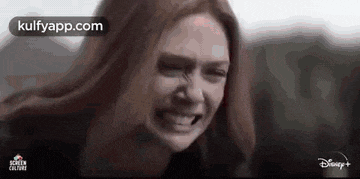 a close up of a woman 's face with a tear running down her face .