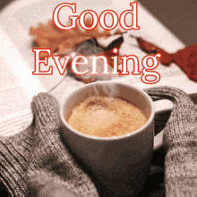 a cup of coffee with the words " good evening " written on it