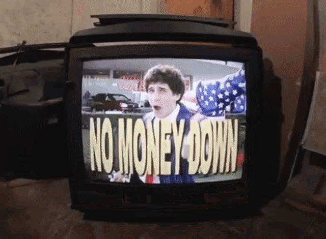 a tv screen shows a man with an american flag and the words no money down
