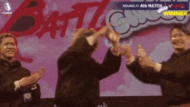 a group of people are clapping in front of a sign that says battle