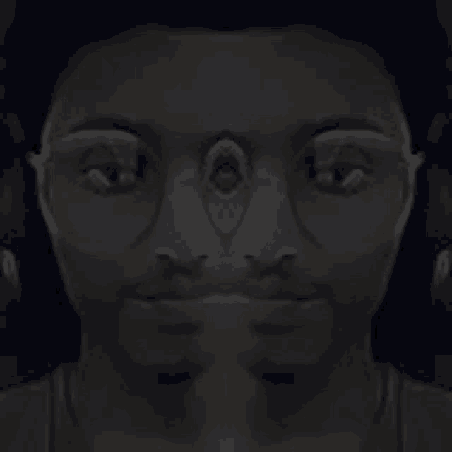a black and white photo of a man 's face with a beard and headphones .