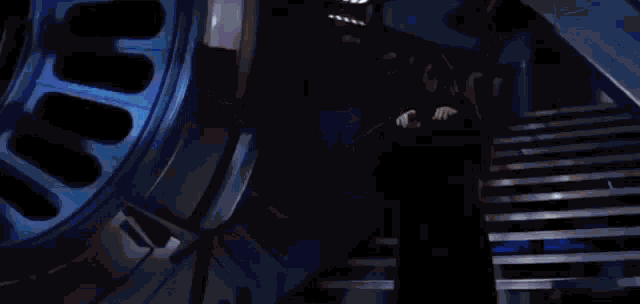 a person is holding a light saber in their hand and it is glowing blue .