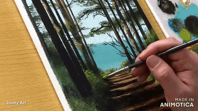 a person is painting a forest path with a brush and the words made in animatica on the bottom right