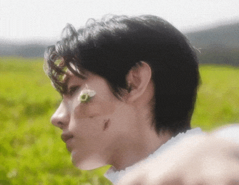 a close up of a person 's face with a flower on it .