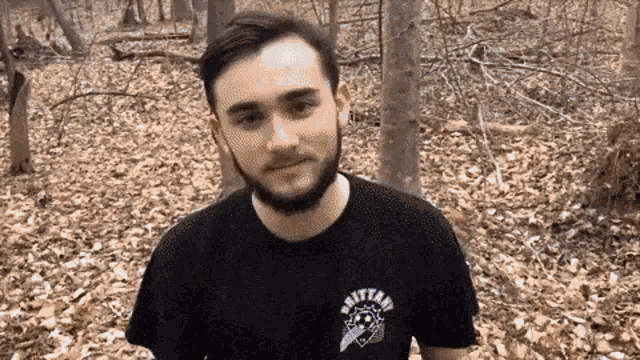 a man with a beard is wearing a shirt that says brittani