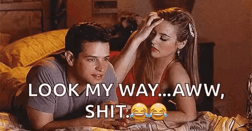 a man and a woman are laying on a bed .